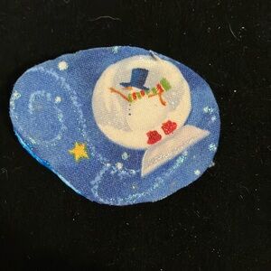 Handmade winter wonderland snowman pin.  Bar clasp. Clay and fabric. 2”X2.5”
